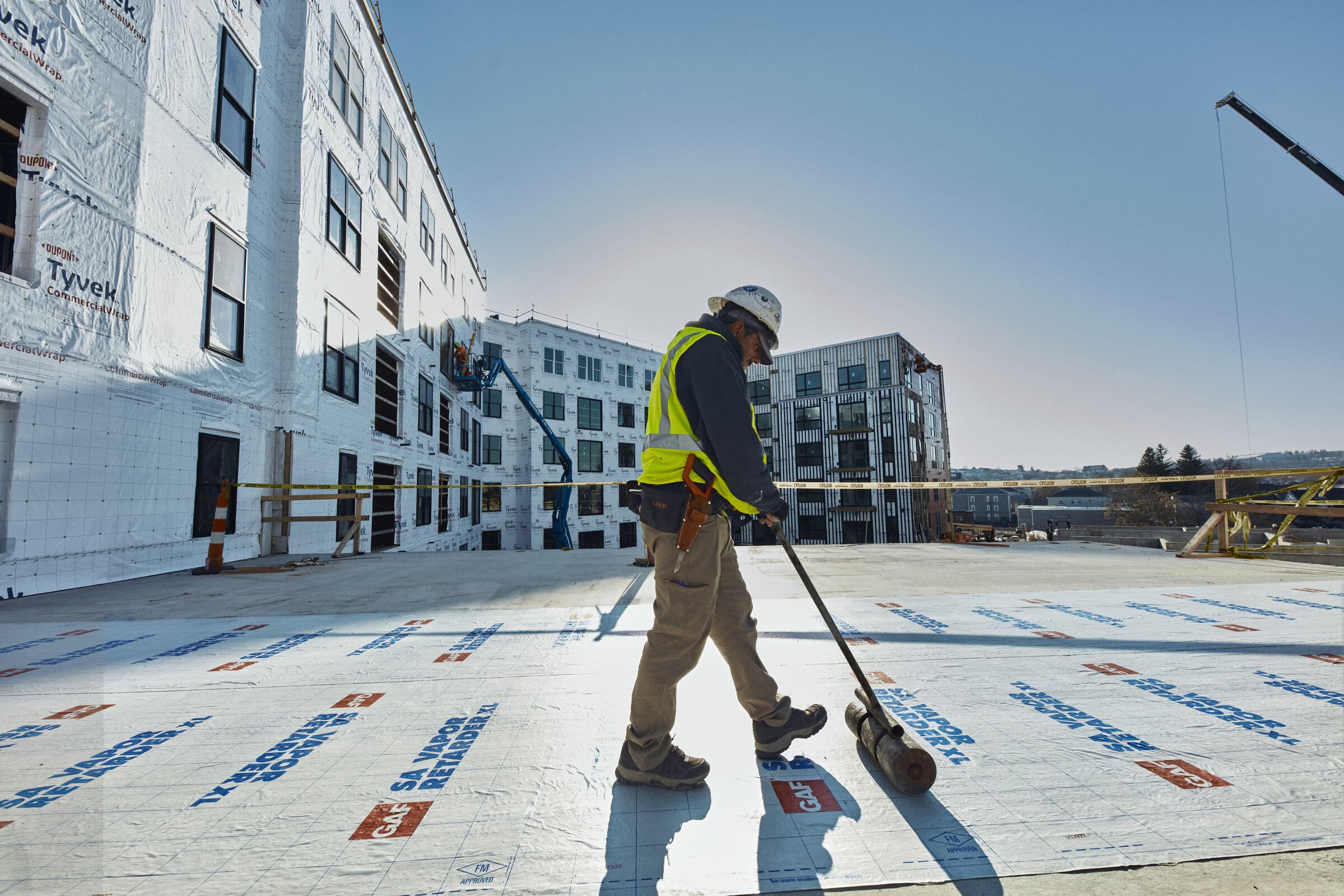 Commercial flat roof membrane installation on a multi-story building