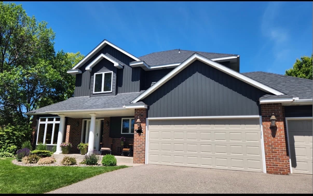 New charcoal siding and roof on a Twin Cities home by Ace Restoration