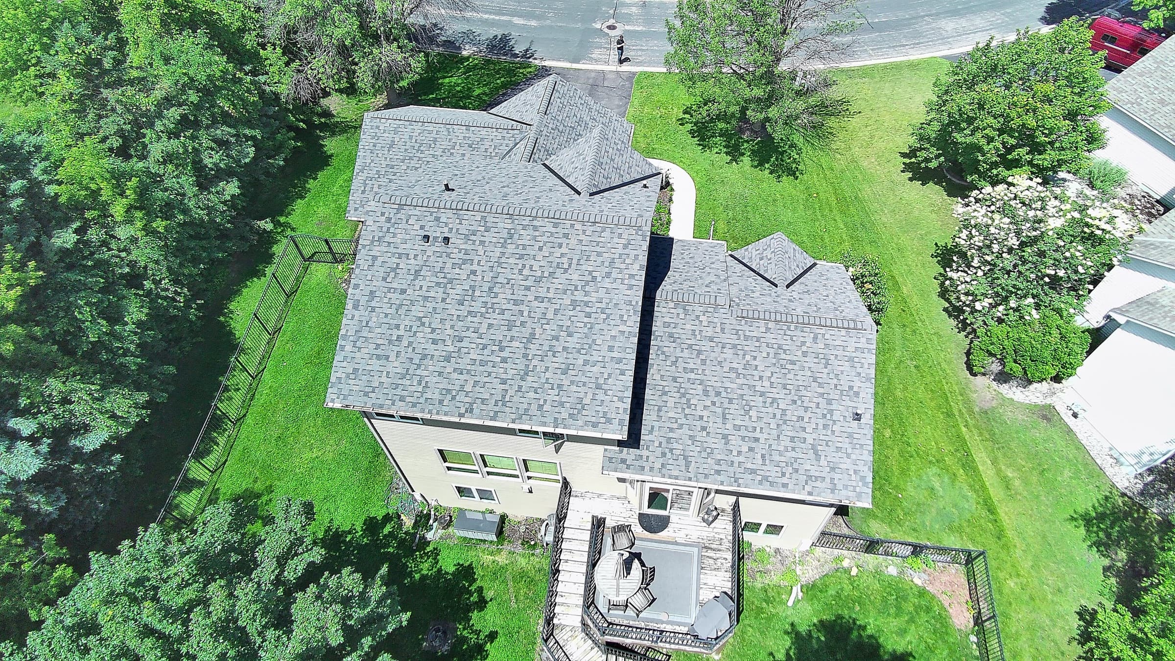 Top-down aerial view of a completed asphalt shingle roof by Ace Restoration